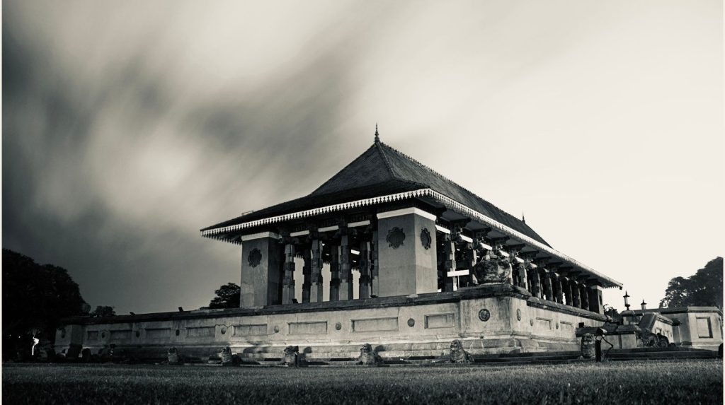 Black and white photo of Independence Memorial Hall in Colombo with stone pillars.