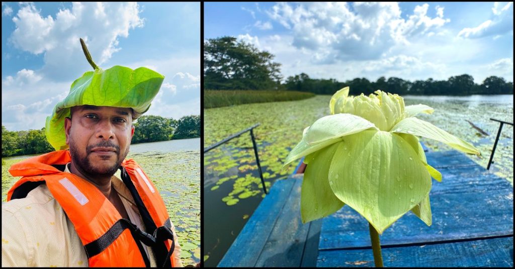 Person wearing a leafy hat and holding a lotus flower beside a boat on Hiriwadunna Lake during a catamaran village tour in Sri Lanka.