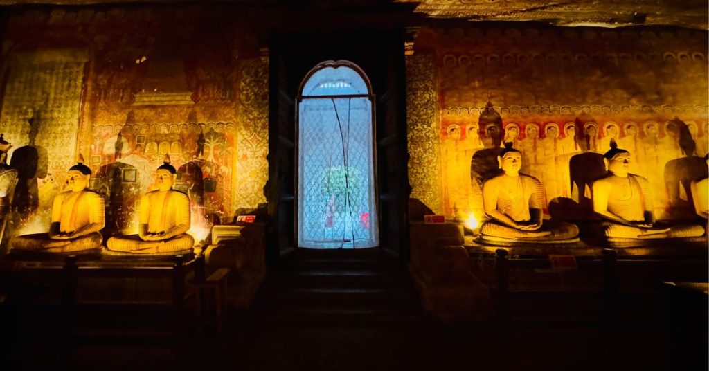 Inside view of Dambulla Cave temple with multiple Buddha statues seated and standing in meditation and serene poses.