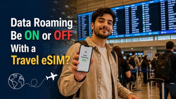 Traveler at airport holding smartphone showing “Data Roaming ON” screen, with question text asking if data roaming should be on or off with a travel eSIM.